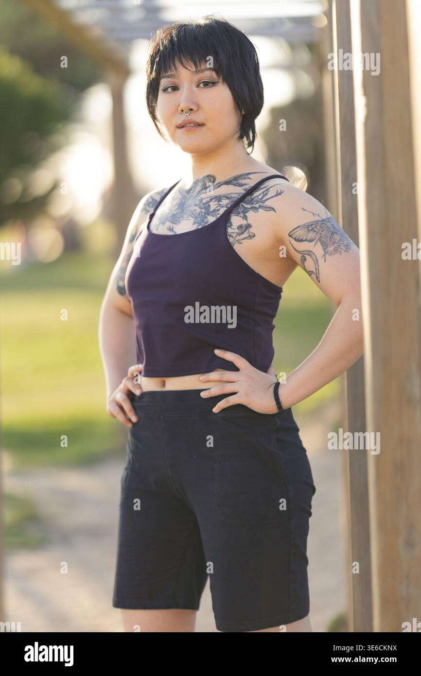 An asian woman with a full body body tattoo, in a japanese style