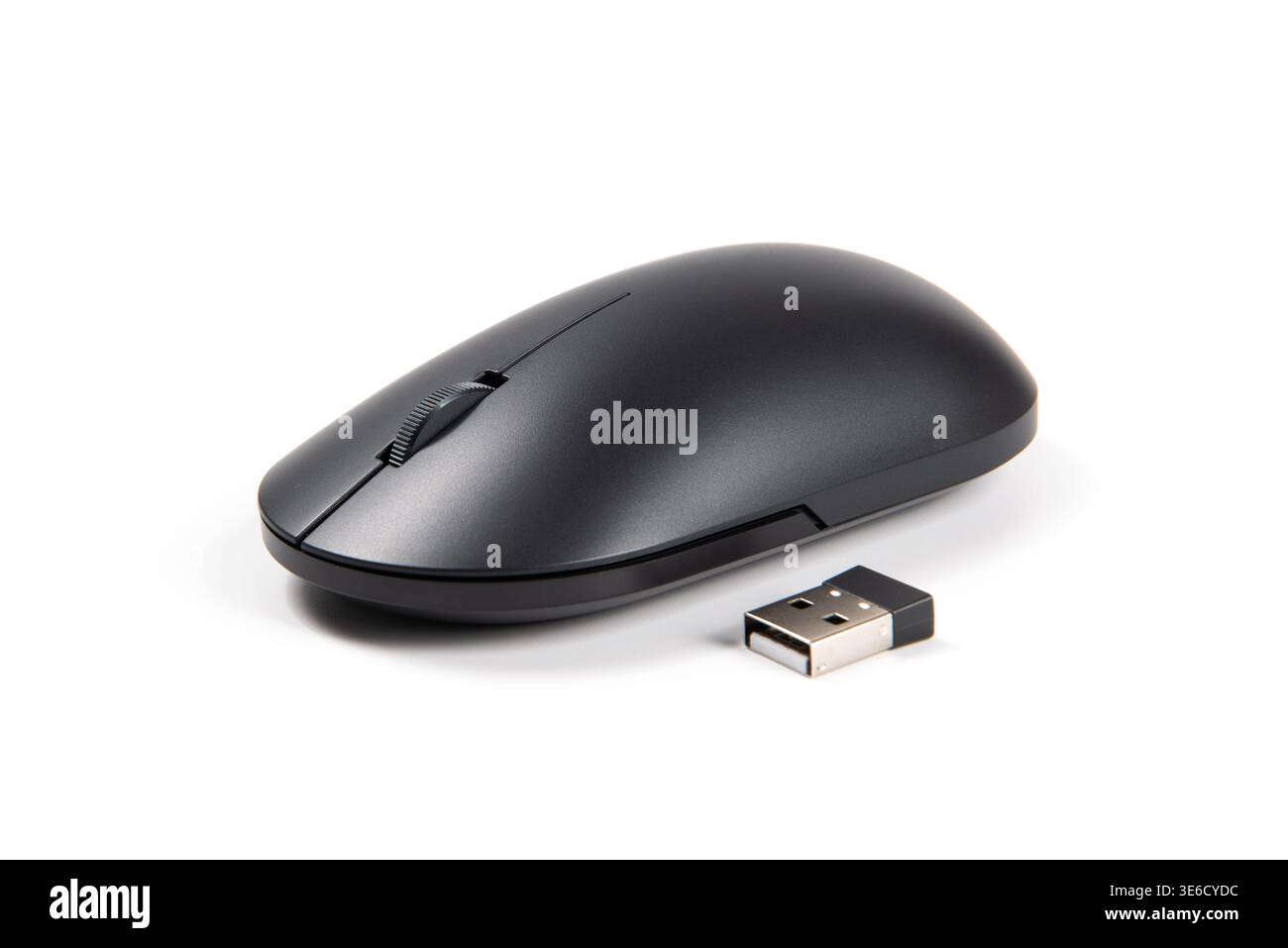 Black wireless optical mouse lying next to its usb receiver on a white background Stock Photo