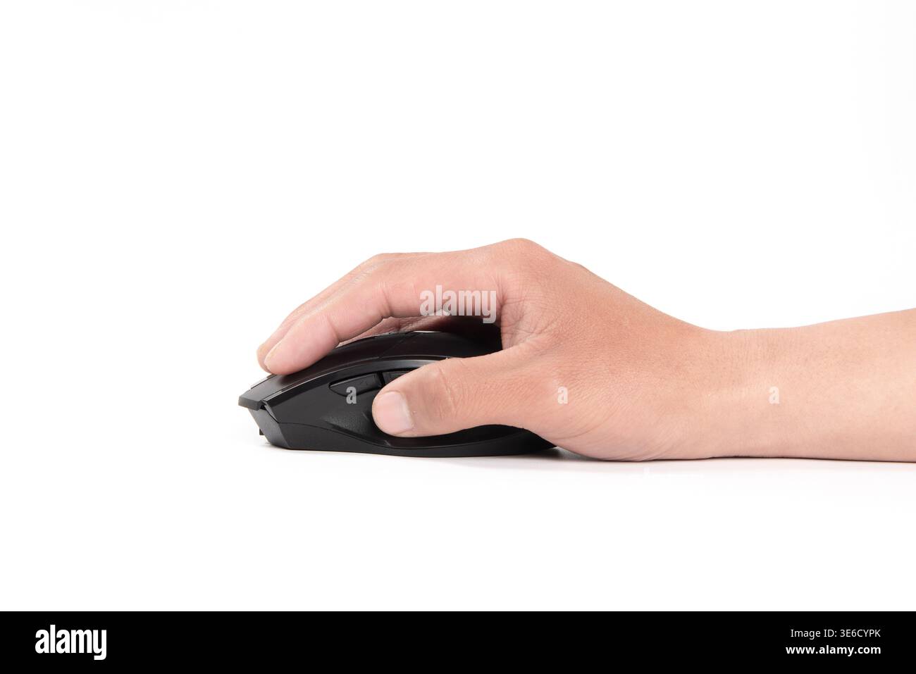 Hand resting on and manipulating a dark computer mouse creating an action Stock Photo