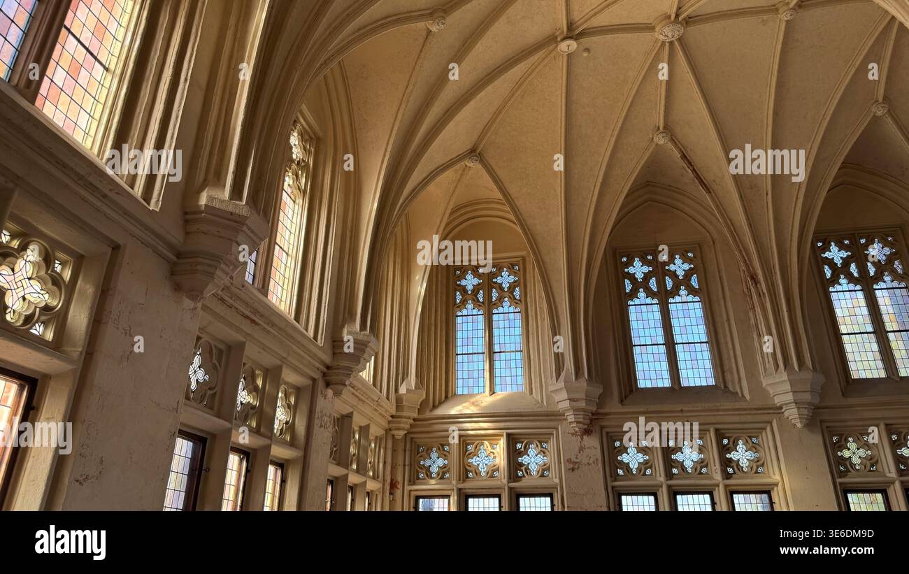 Large gothic hall with high vaulted ceiling tall windows and stone ...