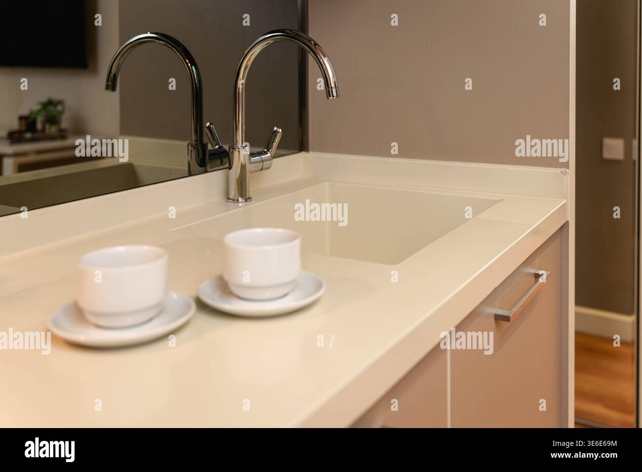 Kitchen Surface with Two White Cups on Saucers Stock Photo
