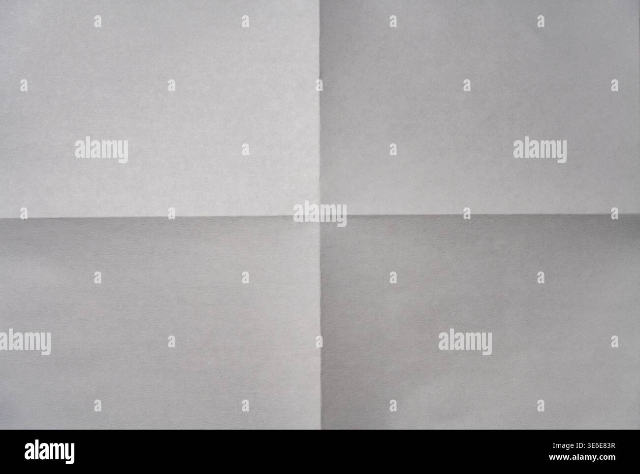 Minimalist background of a white paper sheet folded into four quarters ...