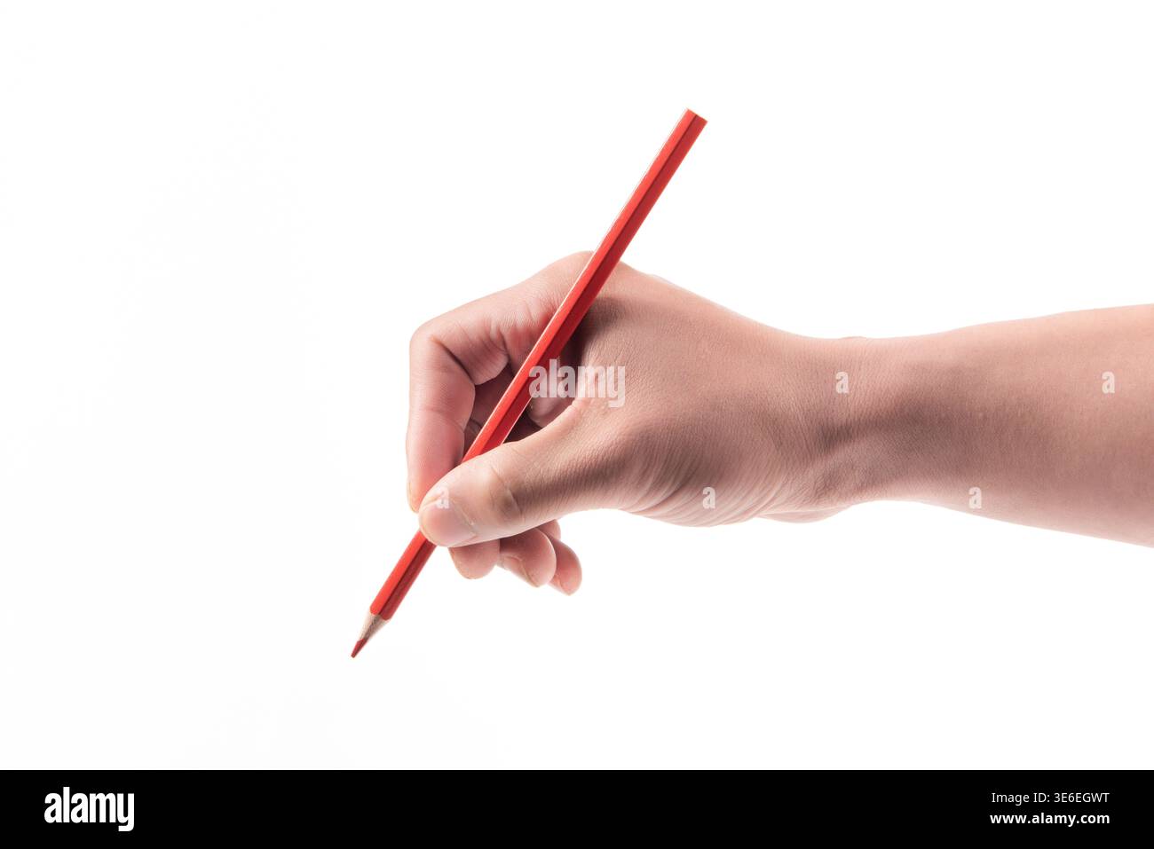 Hand holding a red colored pencil, ready for writing or drawing on a blank background Stock Photo