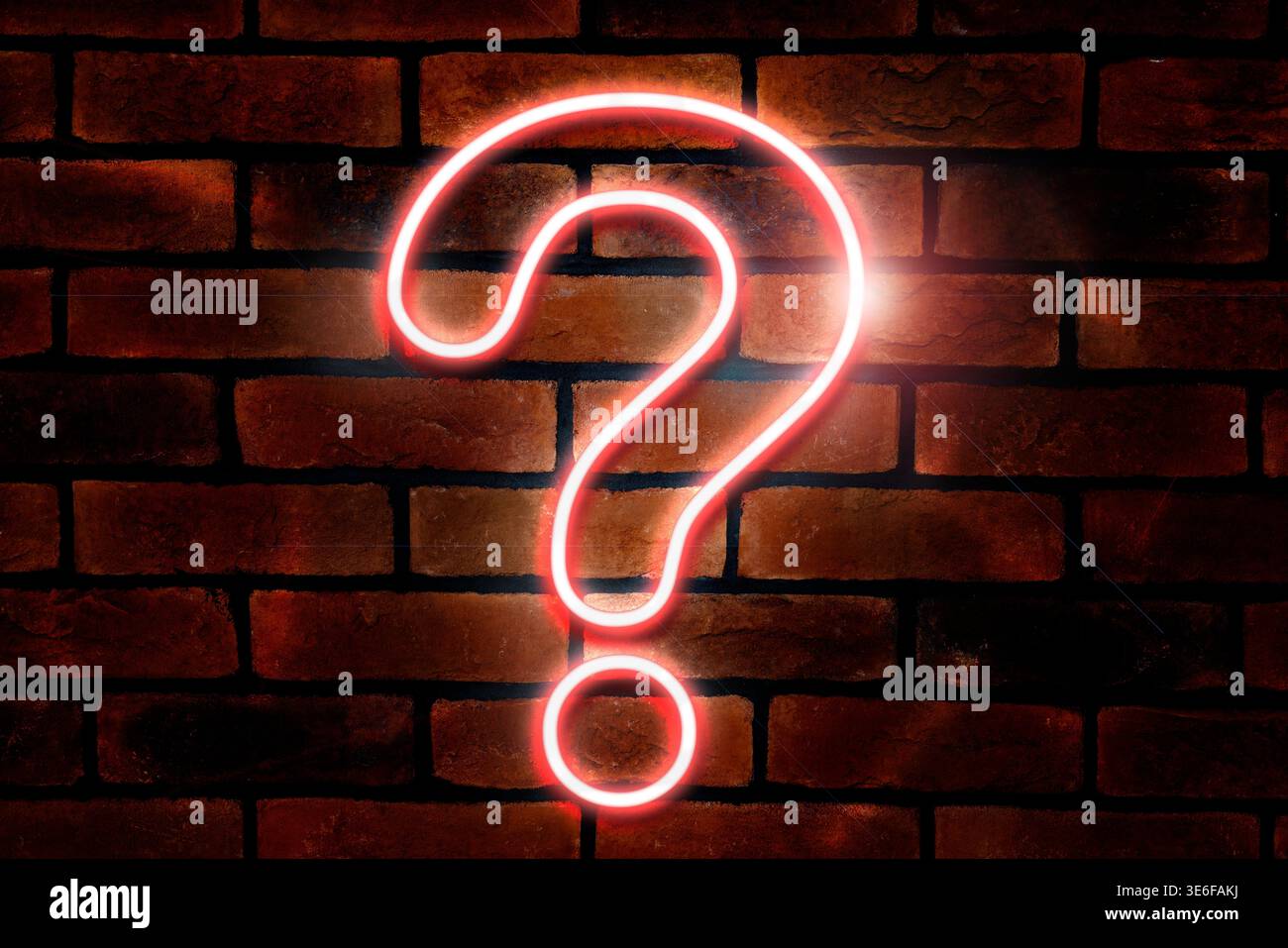 One neon question mark on brick wall Stock Photo