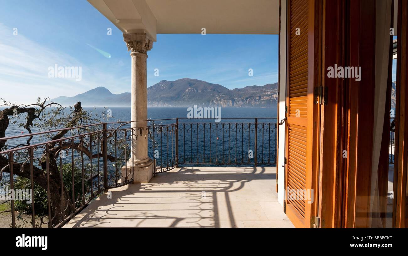 Sunlit terrace of a luxury lakeside villa overlooking a calm Italian ...