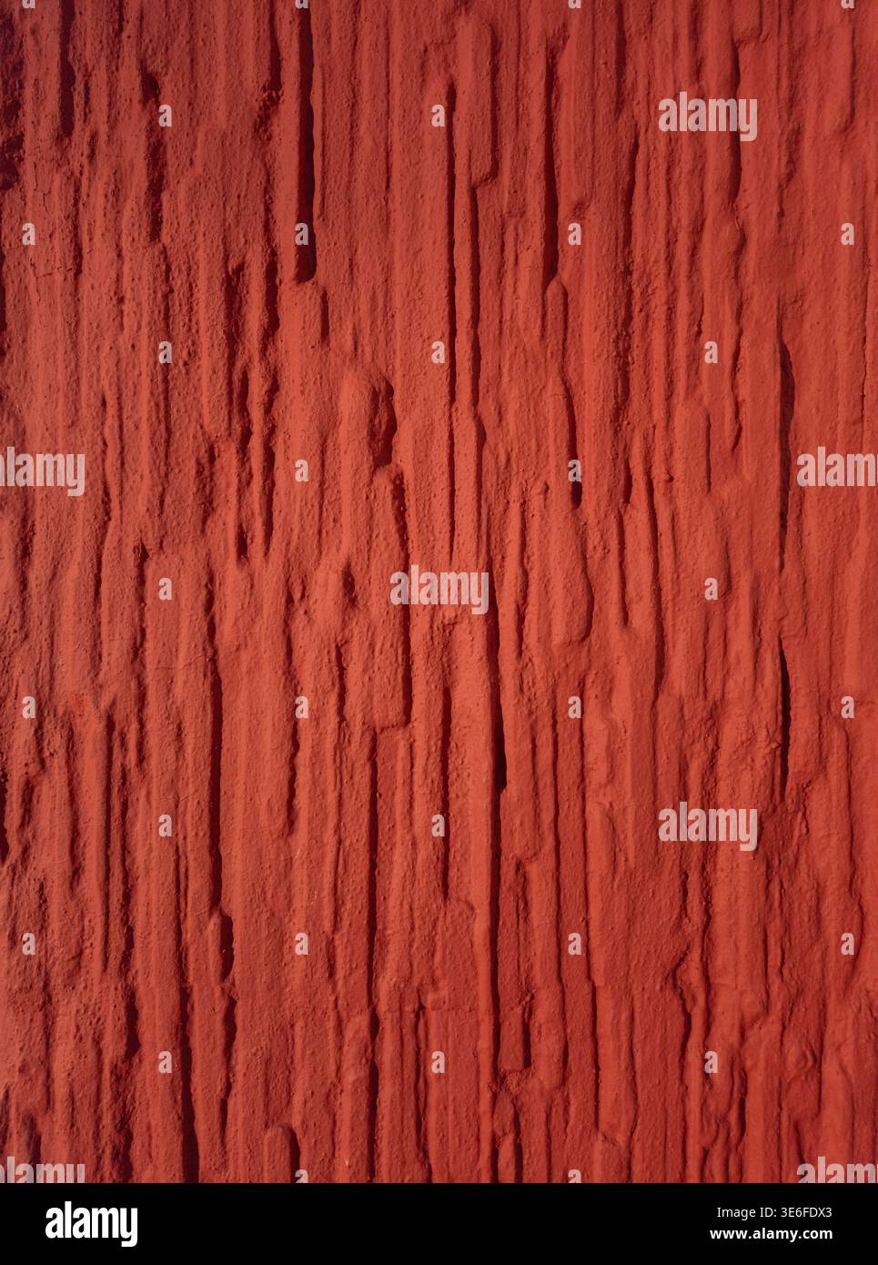 High resolution red textured wall background with rough vertical structure. Abstract surface suitable for design, backgrounds and creative projects. Stock Photo