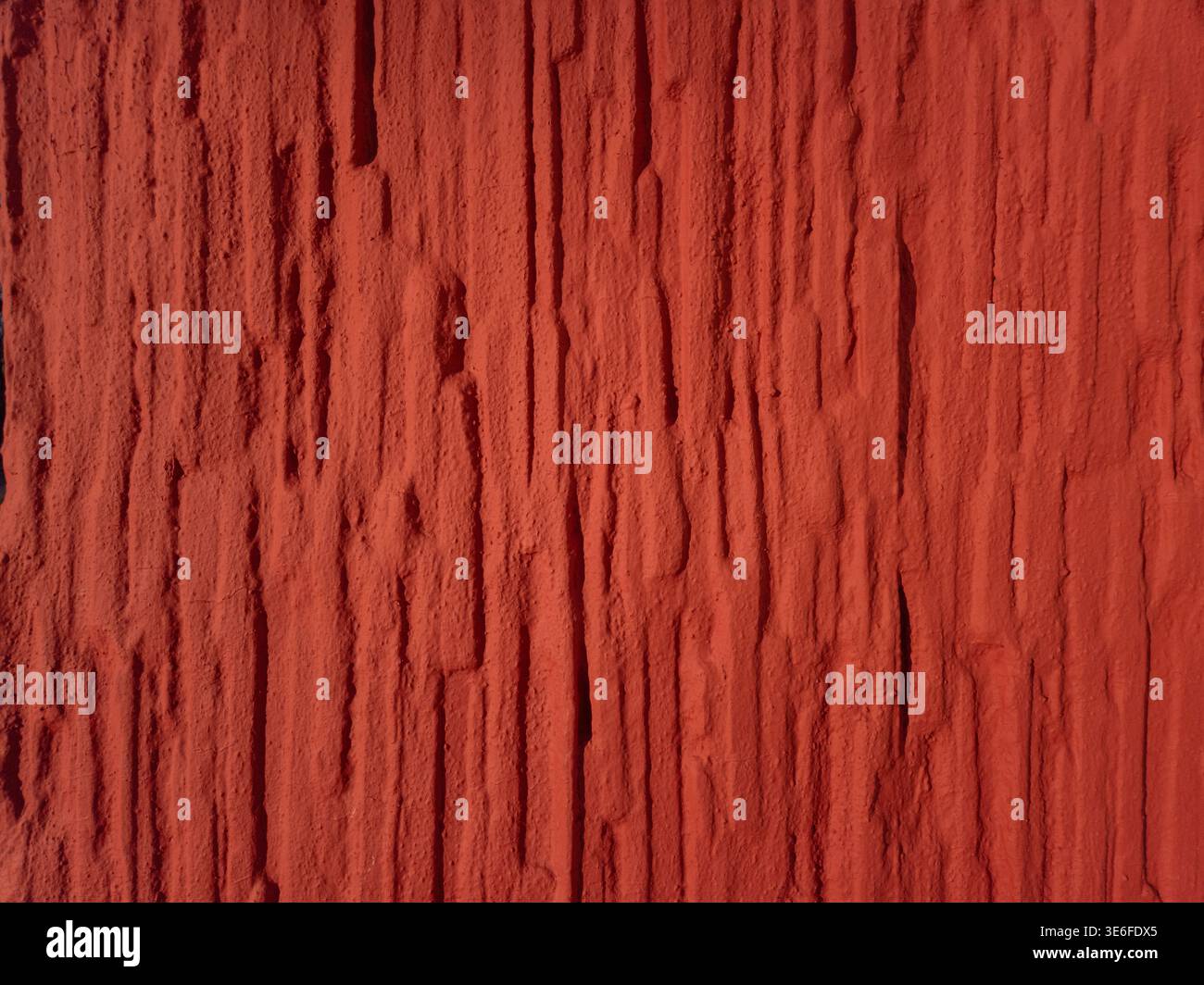 High resolution red textured wall background with rough vertical structure. Abstract surface suitable for design, backgrounds and creative projects. Stock Photo