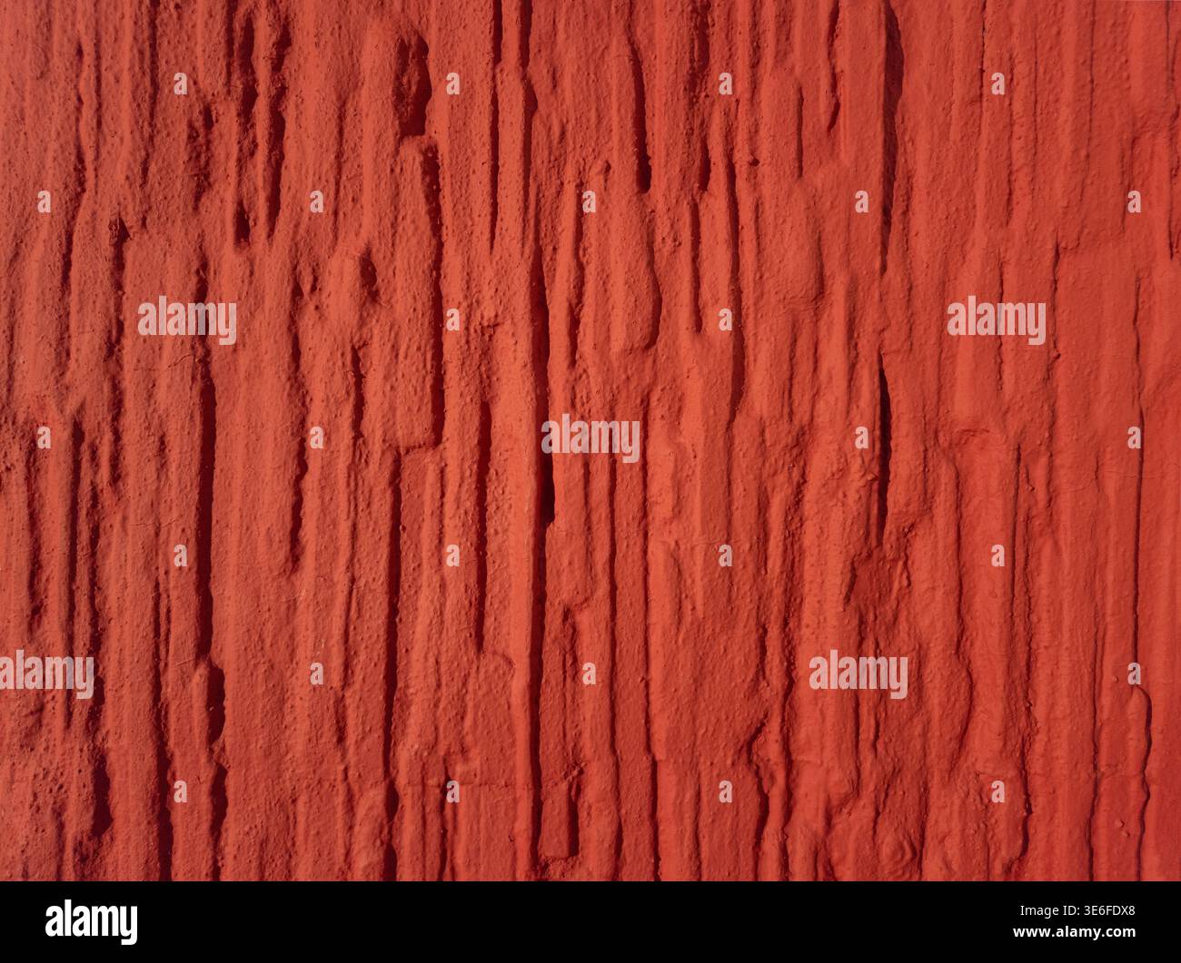 High resolution red textured wall background with rough vertical structure. Abstract surface suitable for design, backgrounds and creative projects. Stock Photo