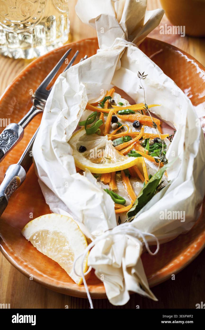 Cod fillets baked in parchment paper Stock Photo