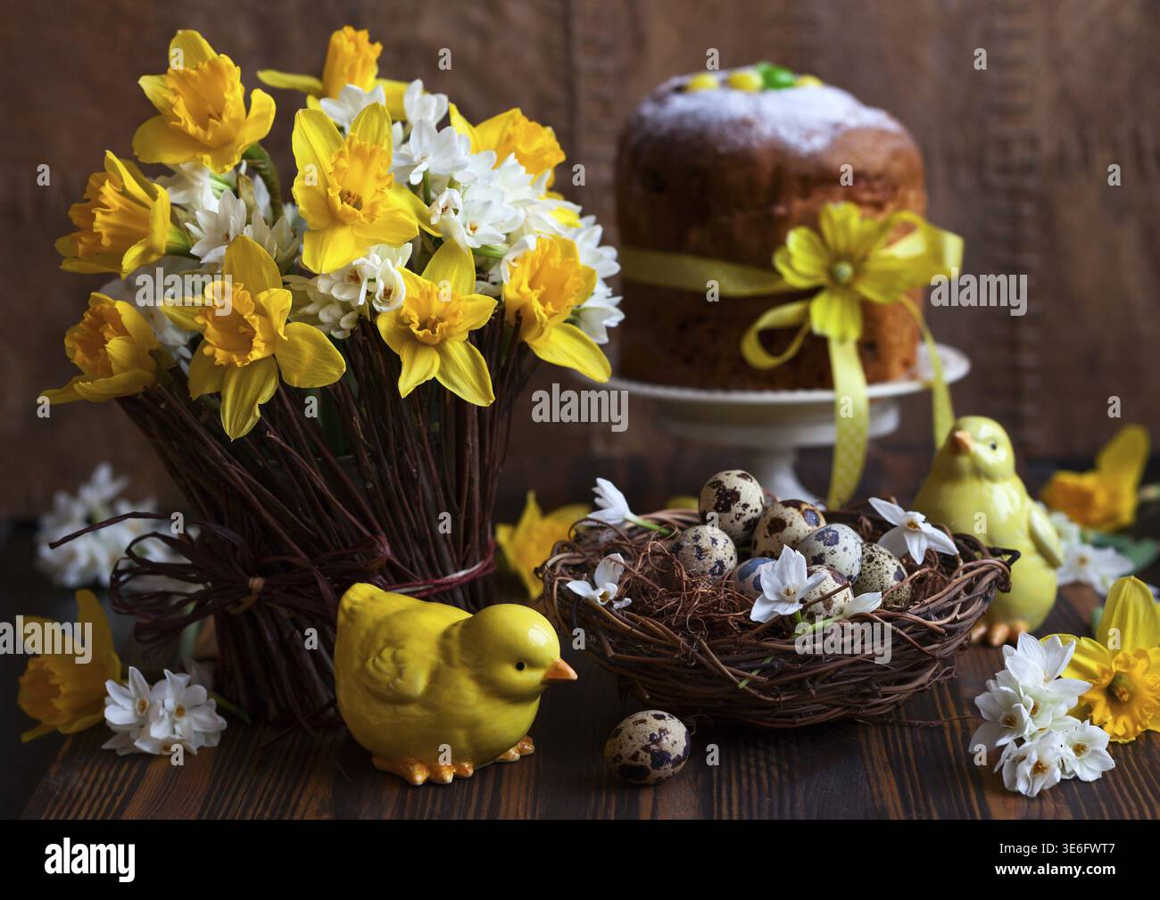 Easter table decoration with fresh daffodils, chick and eggs Stock Photo