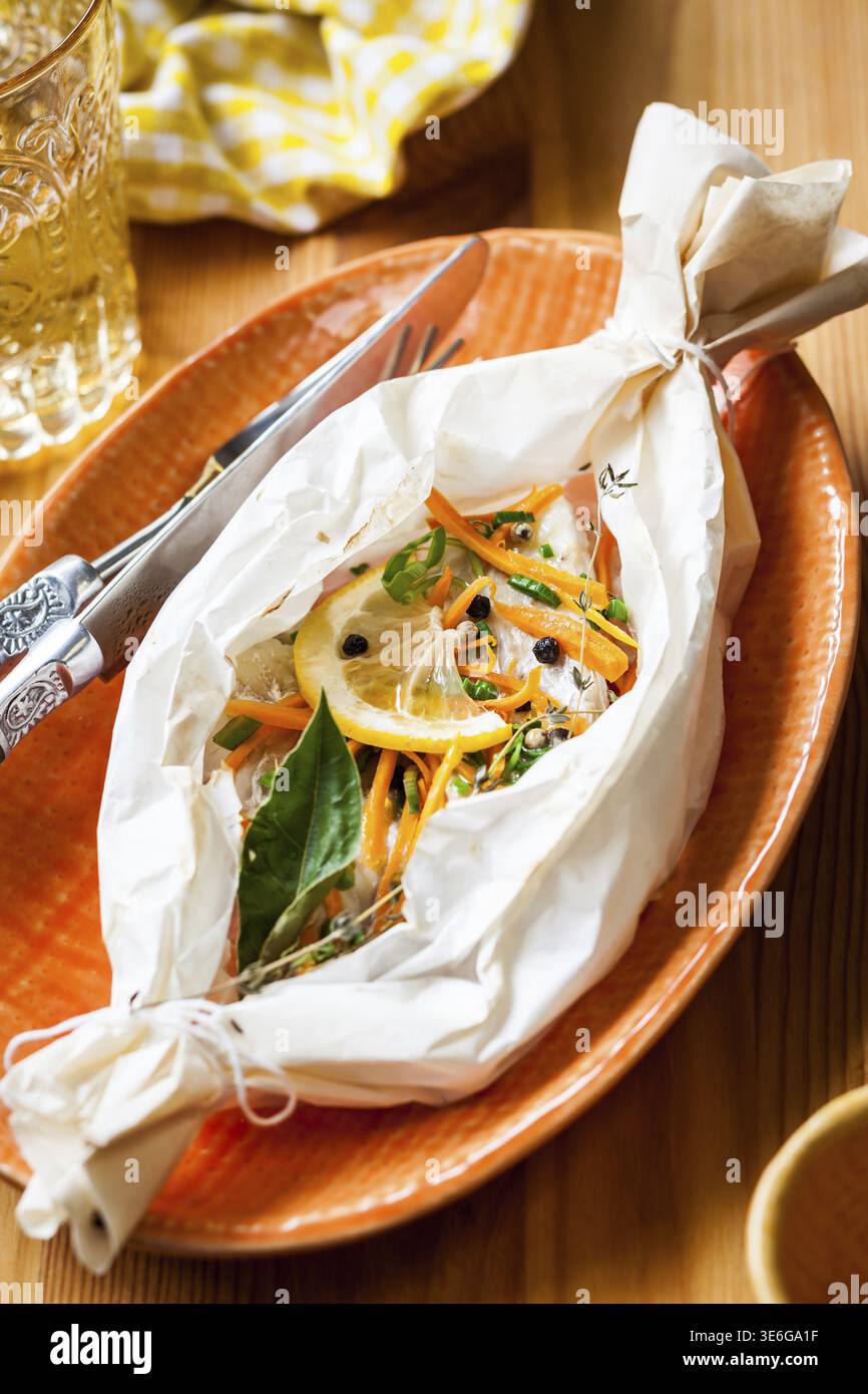 Cod fillets baked in parchment paper Stock Photo