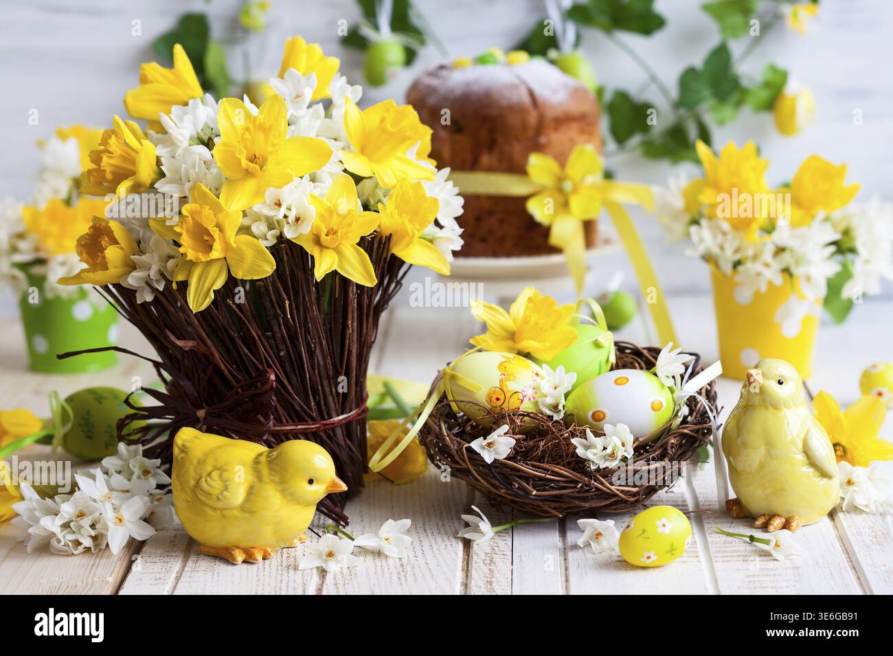 Easter table decoration with fresh daffodils, chick and eggs Stock Photo