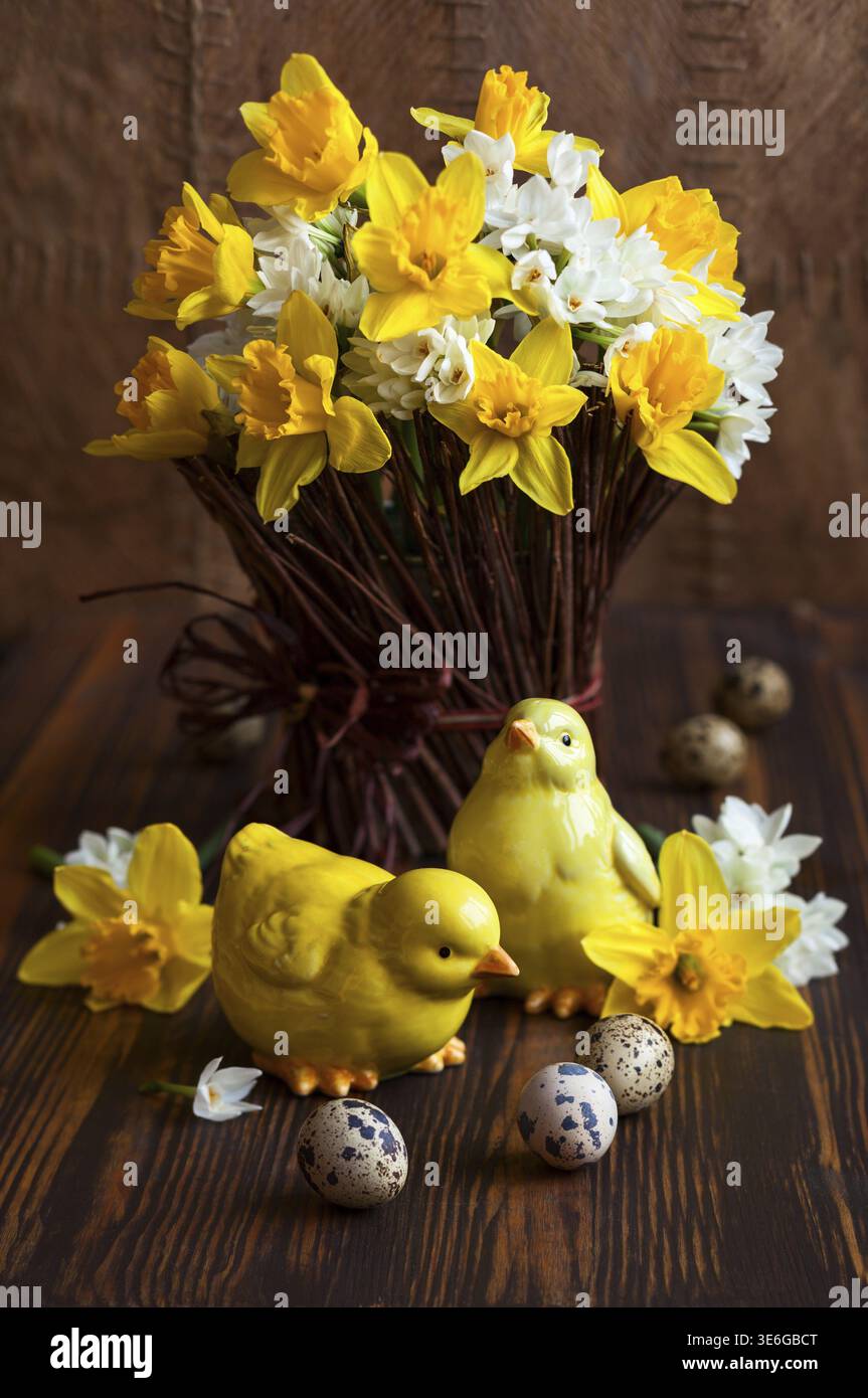 Easter table decoration with fresh daffodils, chick and eggs Stock Photo