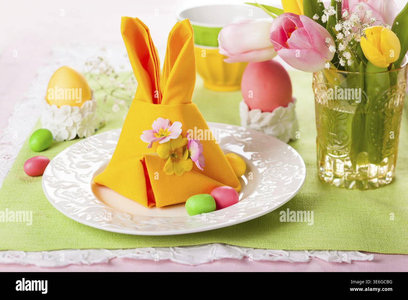 Festive table setting with Easter bunny napkin Stock Photo