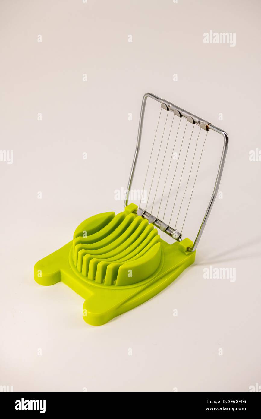 Egg slice or Egg cutter for cutting boiled eggs isolated on white background. Selective focus. Stock Photo