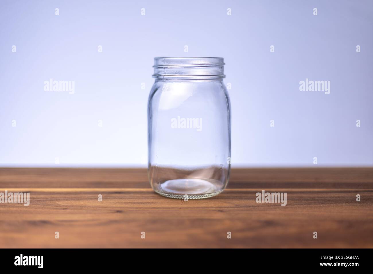 Empty Glass Jar on Wooden Surface with Copy Space Stock Photo