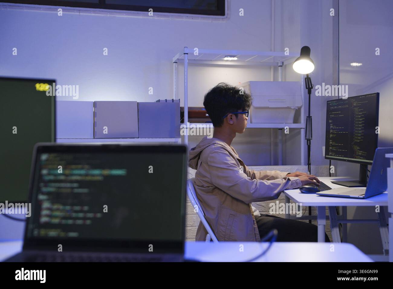 Male Software Engineer Writing Code on Desktop Computer with Multiple ...