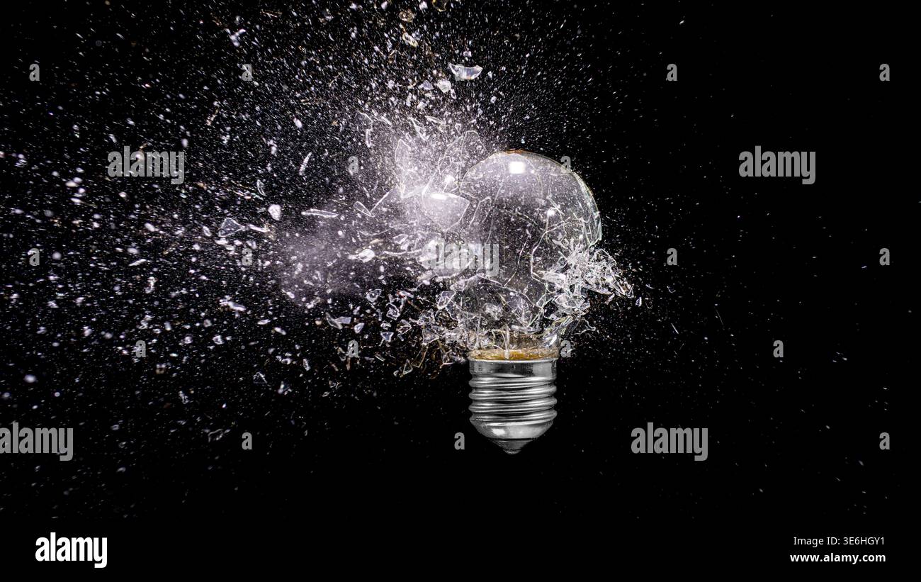 Light bulb real exploding dark background Stock Photo