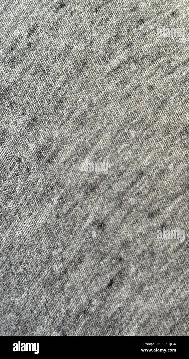 Gray fabric texture with subtle thread pattern ideal for use as a textile background. Mobile photo Stock Photo
