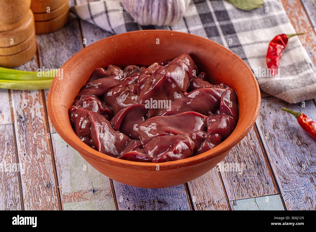 Fresh raw chicken liver in a rustic clay bowl ready for cooking ...