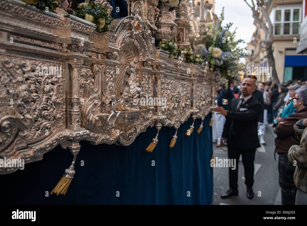 Processional Float Almería, Spain - April 2026: Detailed side view of an ornate silver ...