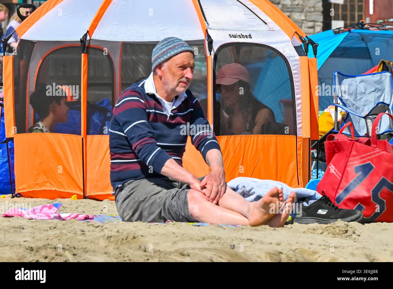 Lyme Regis, Dorset, UK. 7th April 2026. UK Weather. A sunbather on the ...