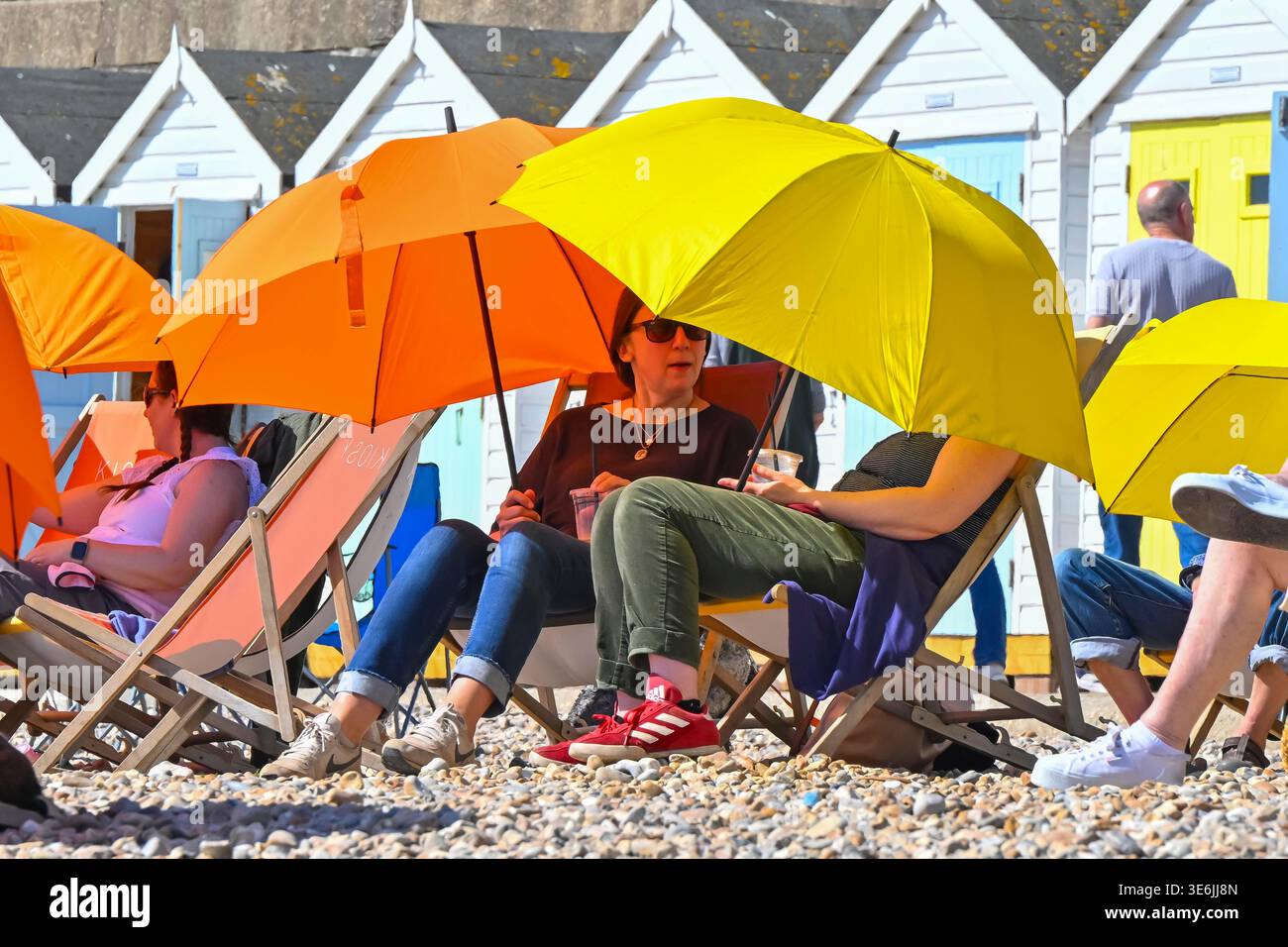 Lyme Regis, Dorset, UK. 7th April 2026. UK Weather. Sunbathers on the ...