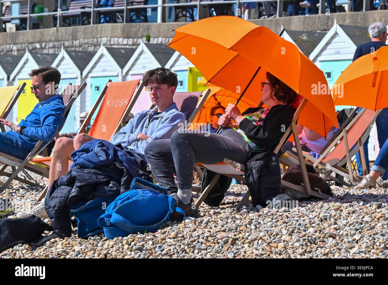 Lyme Regis, Dorset, UK. 7th April 2026. UK Weather. Sunbathers on the ...