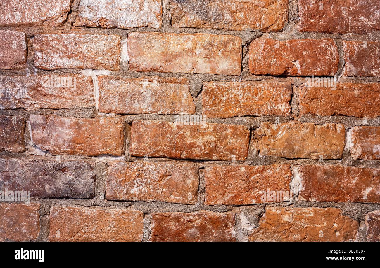 Old weathered red brick wall as creative background, close up Stock Photo