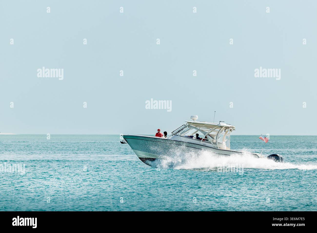 Saltwater fishing boat on a sunny summer day. People on recreational powerboat cruising the Gulf of America, Florida. Stock Photo