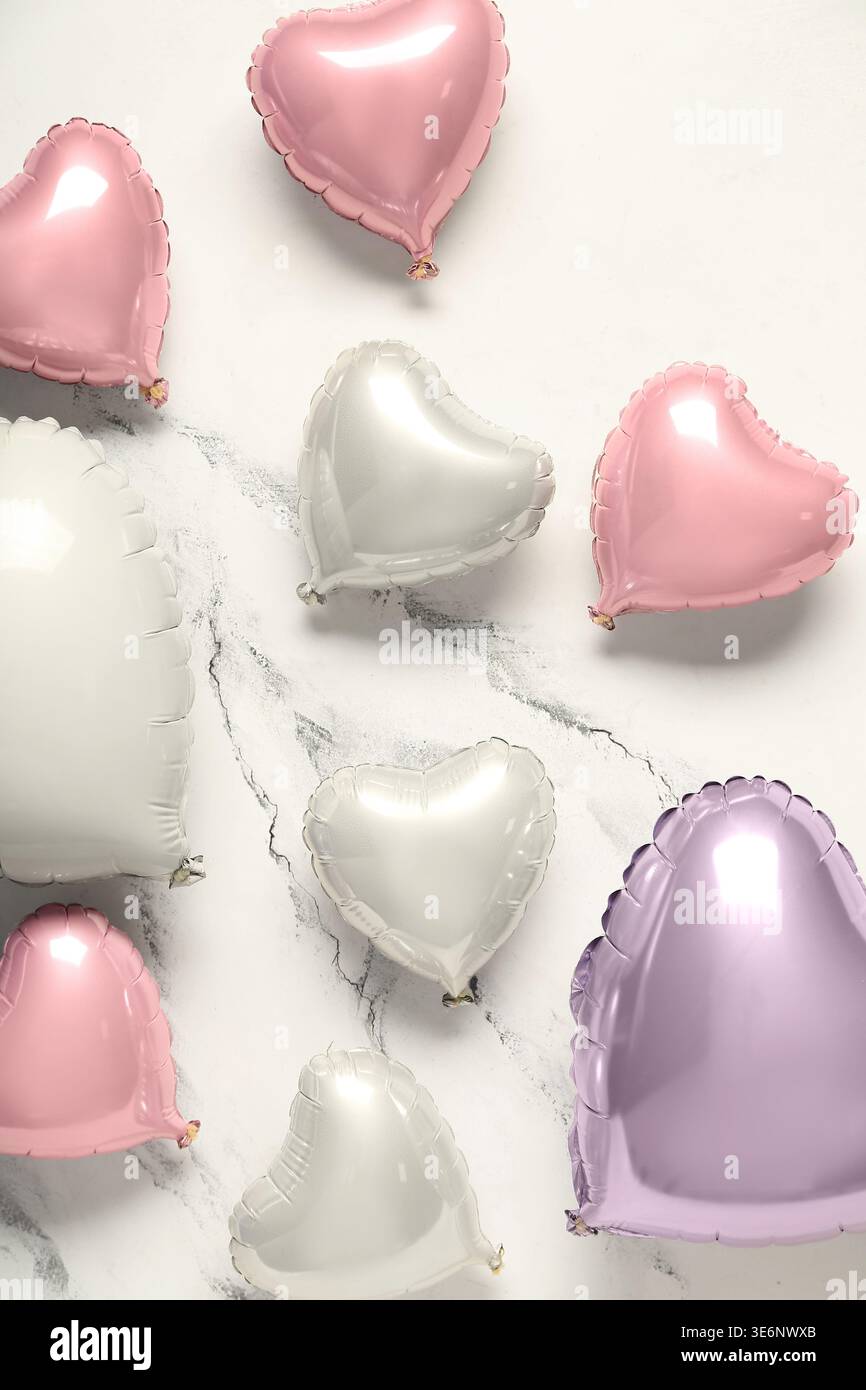 Many heart shaped air balloons on white background. Valentine's day celebration Stock Photo