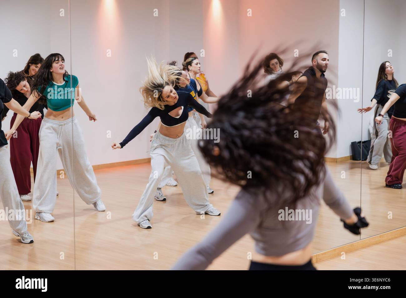 Group of dancers practicing dynamic choreography in studio Stock Photo