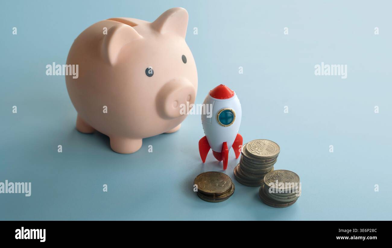 Piggy bank with stacked coins and a toy rocket representing retirement savings and investment growth. Stock Photo