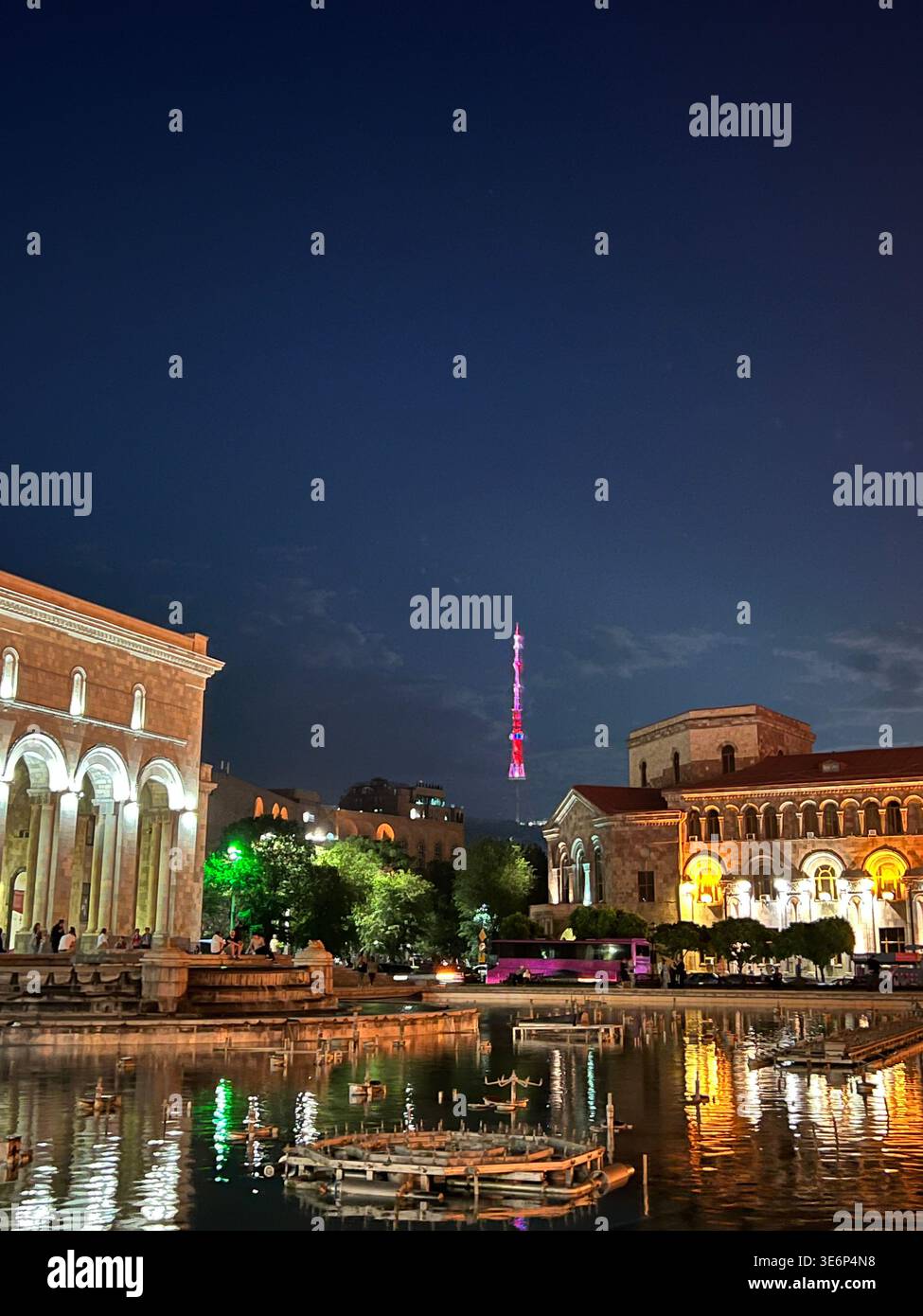 Republic Square fountains at night with the Yerevan TV Tower in the distance, Yerevan, Armenia. - Smartphone Captured Stock Image
