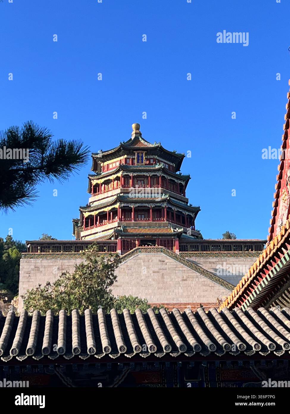 Tower of Buddhist Incense framed by traditional rooftops at the Summer Palace in Beijing, China. - Smartphone Captured Stock Image