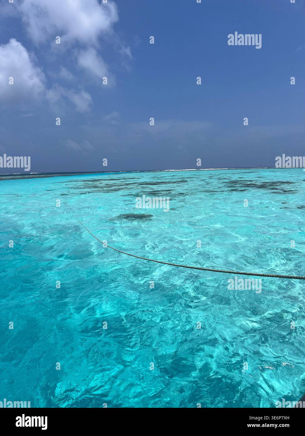 Crystal clear shallow lagoon water over reef in the Maldives - Smartphone Captured Stock Image