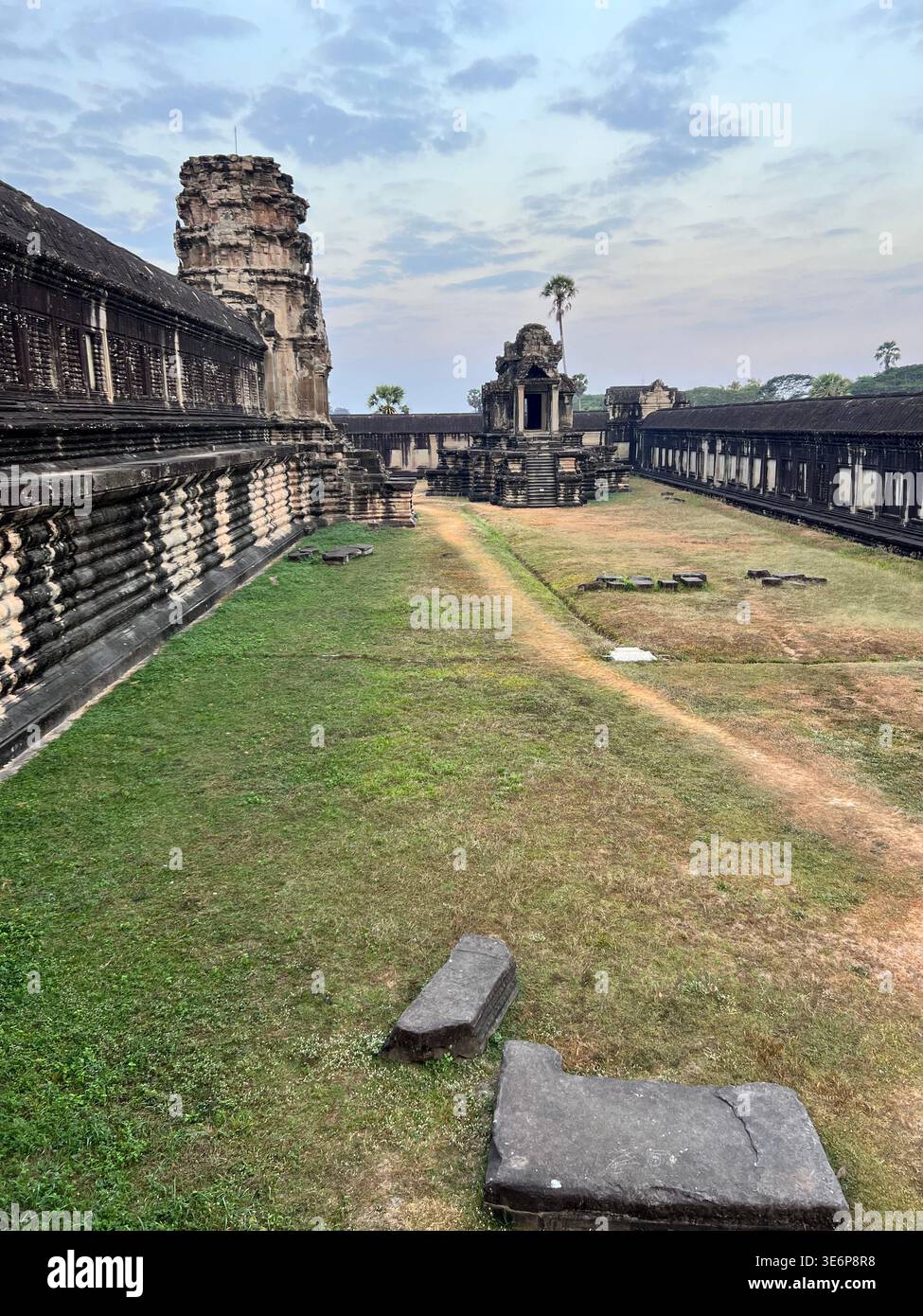 Long stone gallery and grassy courtyard inside Angkor Wat in Siem Reap, Cambodia. - Smartphone Captured Stock Image