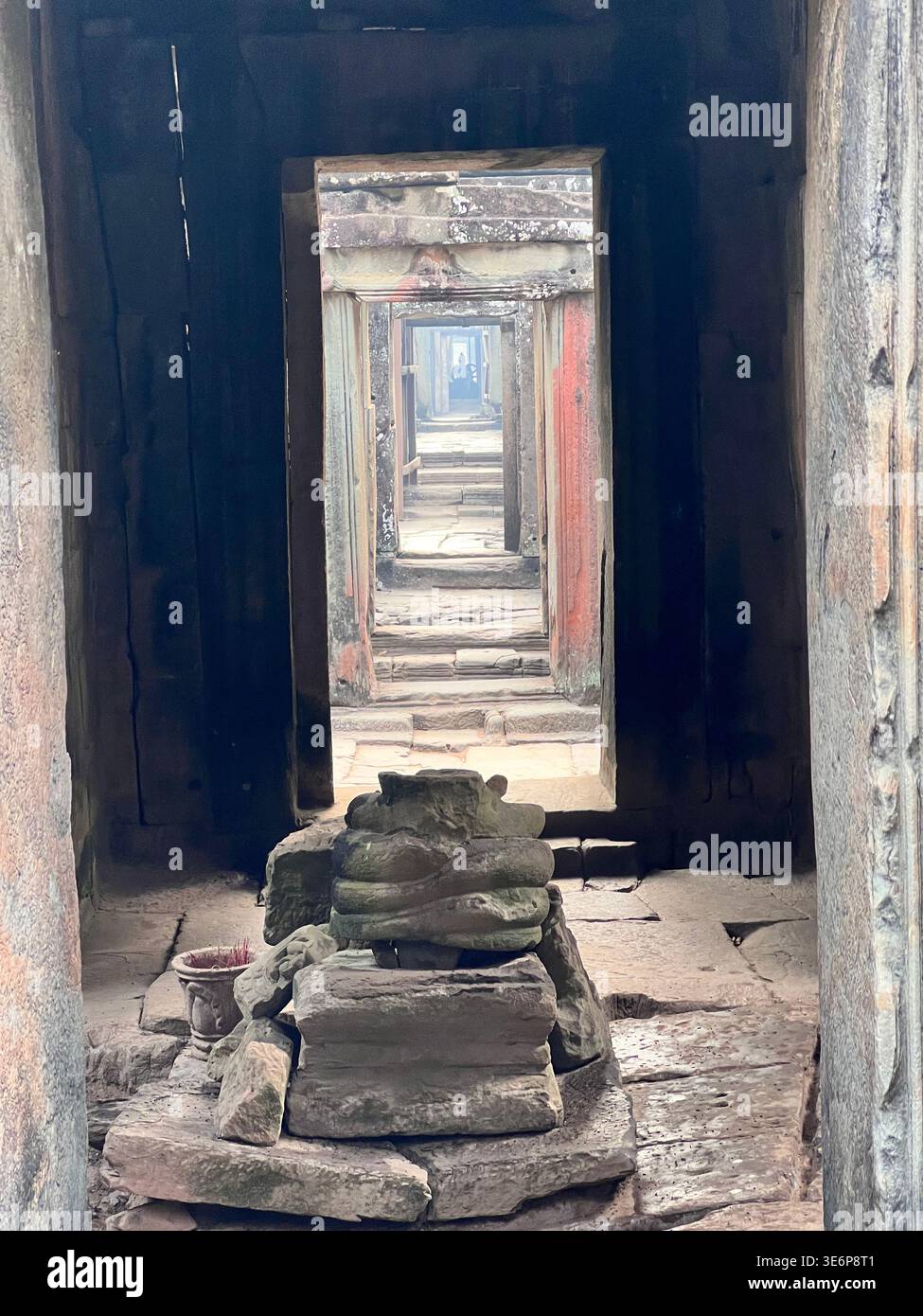 Straight stone passage through aligned doorways at Banteay Kdei in Siem Reap, Cambodia. - Smartphone Captured Stock Image