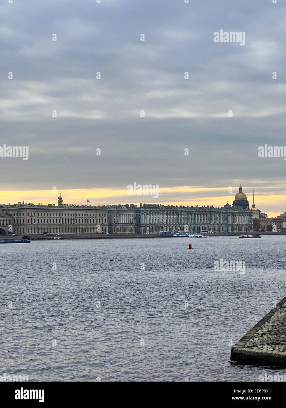 View across the Neva River toward the Winter Palace embankment skyline with Saint Isaac's Cathedral and the Admiralty spire in Saint Petersburg - Smartphone Captured Stock Image