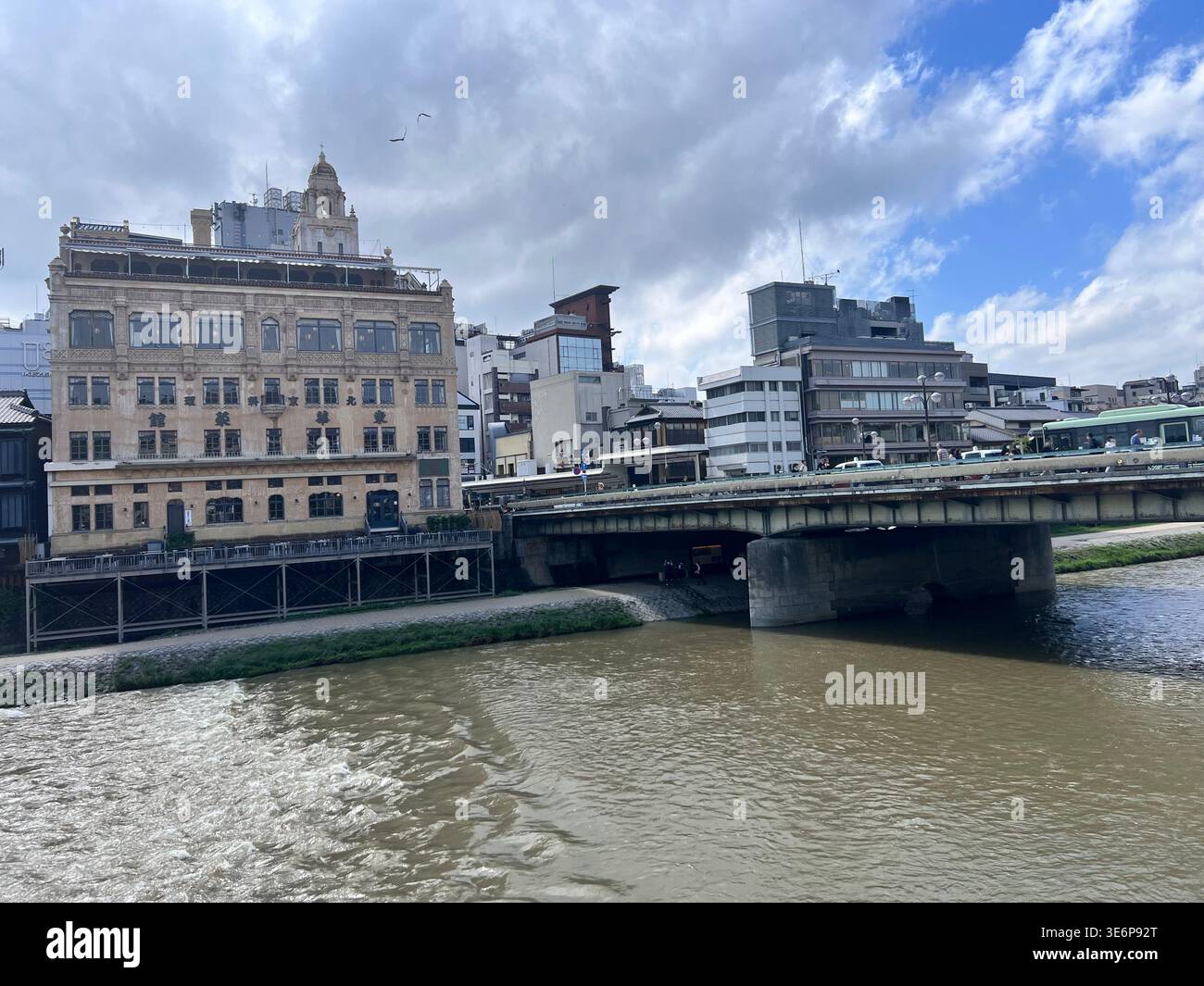 Riverside cityscape with bridge and historic buildings in Kyoto, Japan. - Smartphone Captured Stock Image