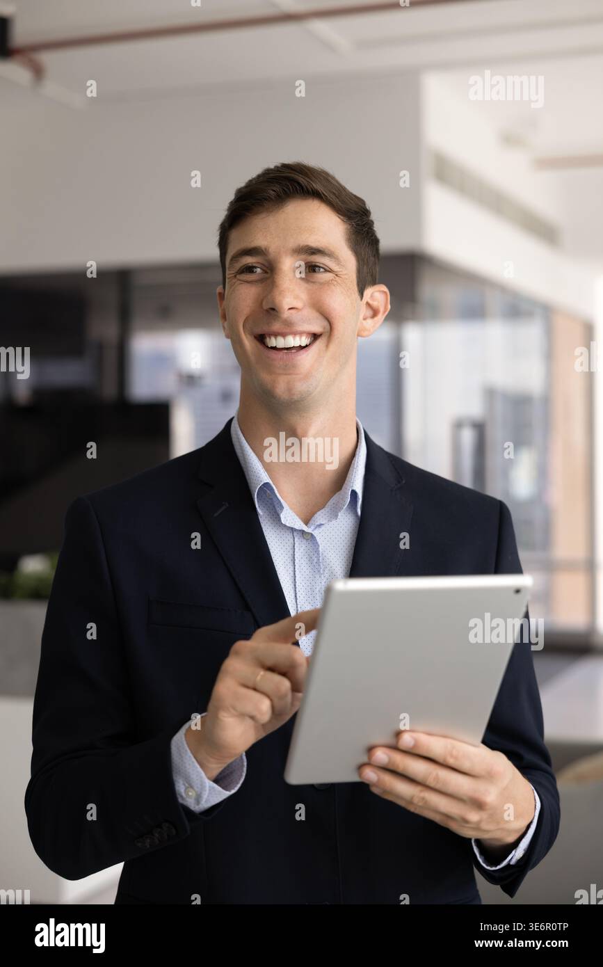 Young smiling male executive holding tablet device Stock Photo