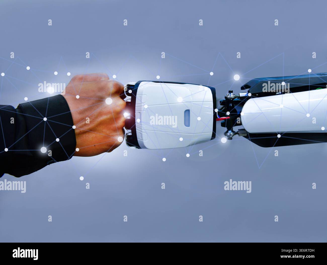 Human and robot fist bump against digital network background, representing future collaboration between man and artificial intelligence Stock Photo