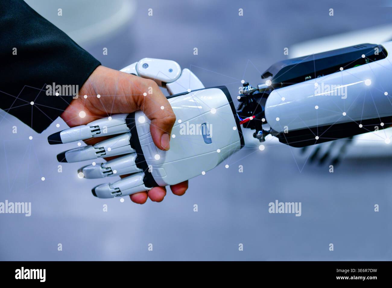 Robot and human handshake representing artificial intelligence collaboration and future technology. Stock Photo