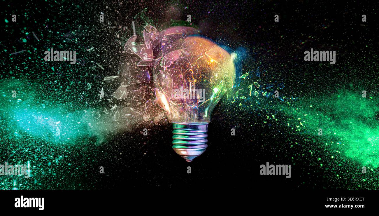 Lightbulb exploding into colorful dust Real shot Stock Photo