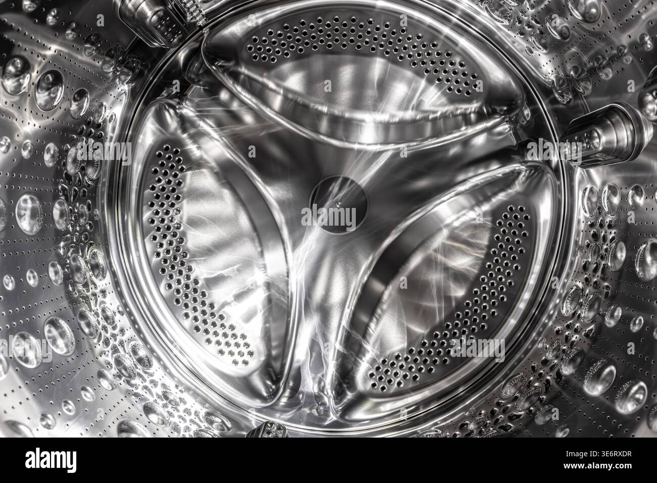 Washing machine drum showing shiny metallic surface Stock Photo