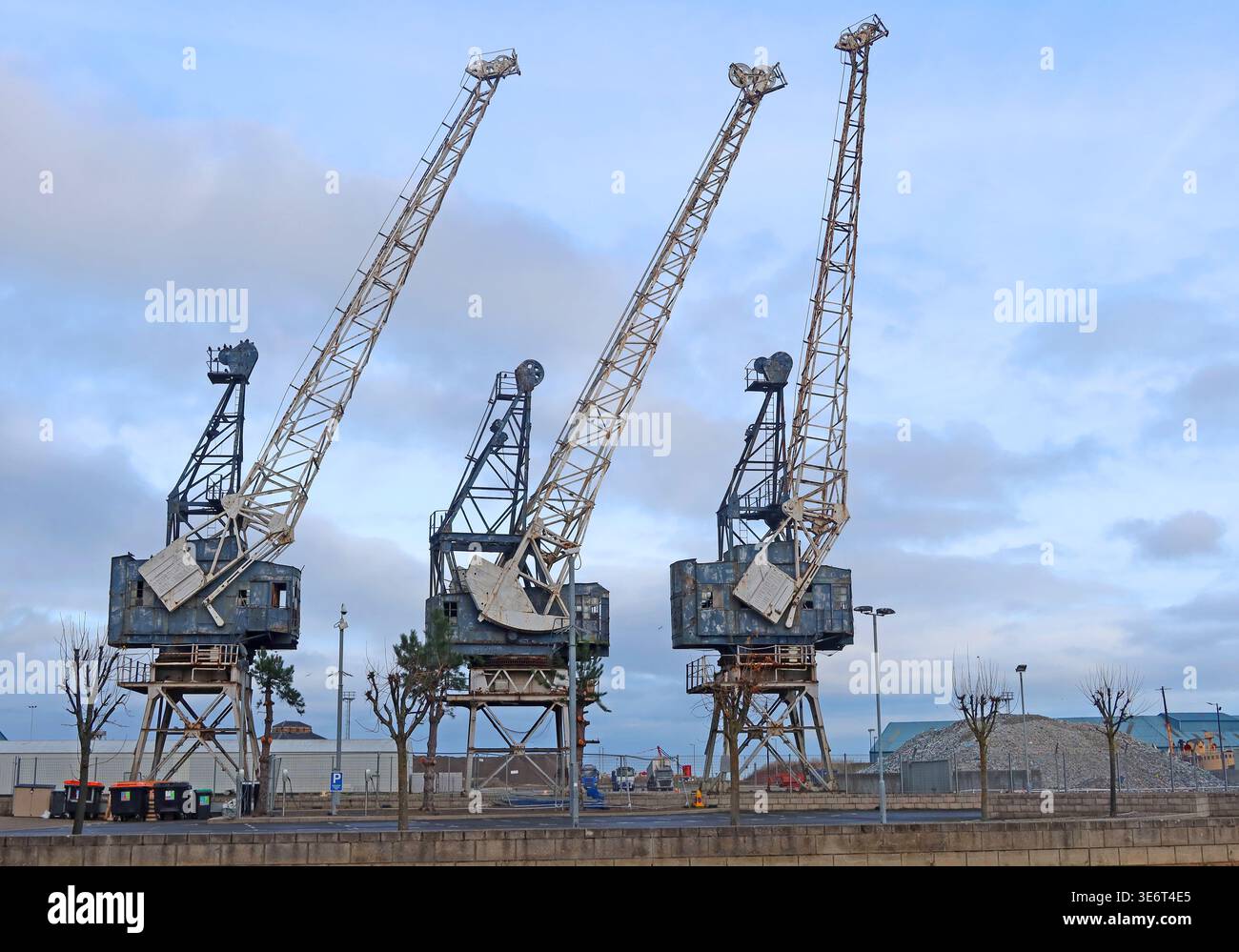 Three historic dock cranes at Leith harbour in Edinburgh, Scotland, beside the Firth of Forth. Stock Photo