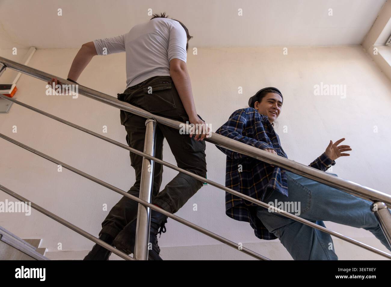 Low angle of students talking on stairs Stock Photo