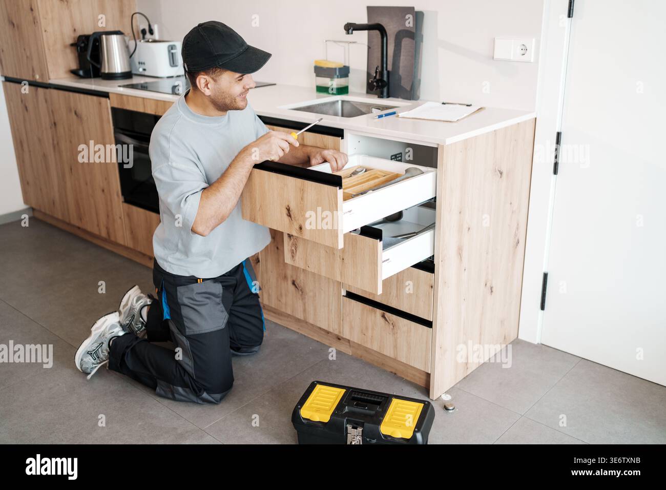 Meticulous Craftsmanship In Verifying And Adjusting Cabinet Parts For Optimal Alignment And Fit Stock Photo