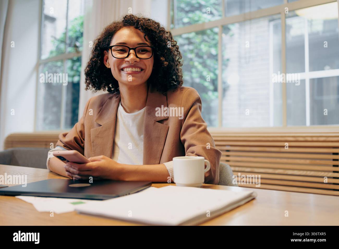 Energized Female Business Owner Working On Innovative Projects Within Lively Workspace Environment Stock Photo