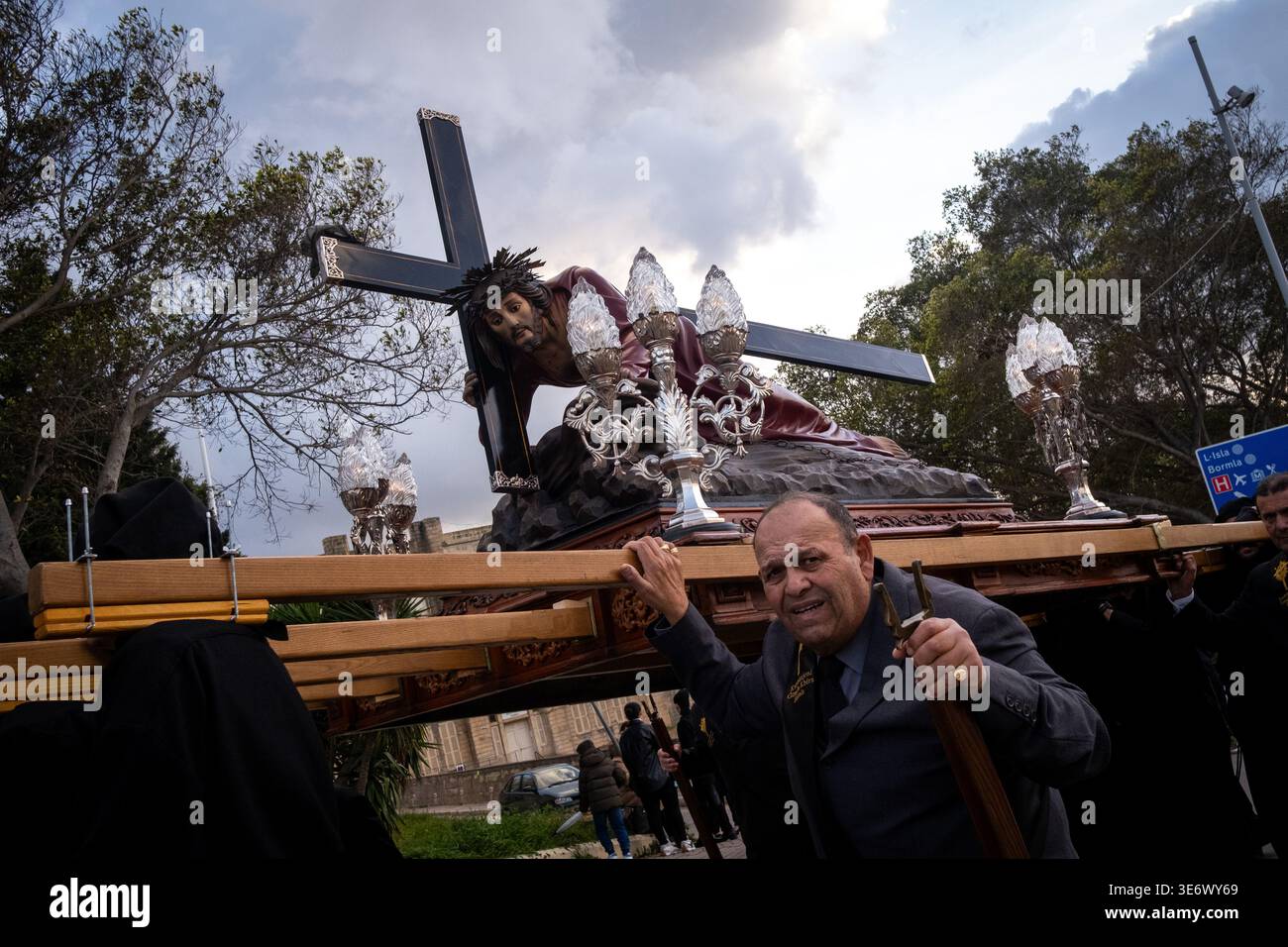 Bearers carry a life size statue showing Jesus fallen beneath the cross ...
